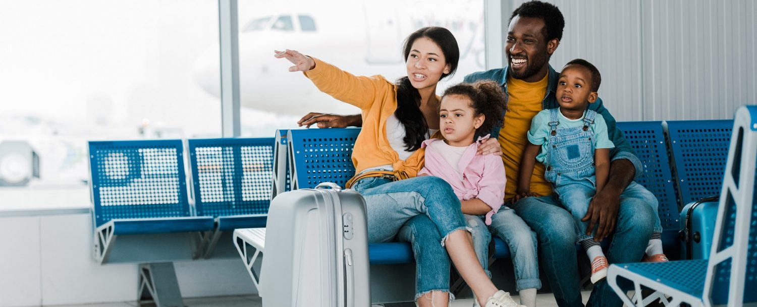 Family waiting to board a plane and enjoying non-stop flights to Charleston, SC