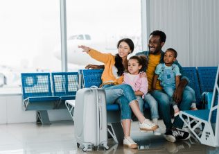 Family waiting to board a plane and enjoying non-stop flights to Charleston, SC